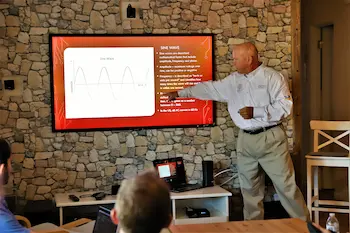 A man presents a home inspection lesson from a screen
